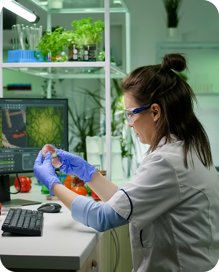 front-view-woman-researcher-analyzing-petri-dish-with-vegan-meat-typing-biological-expertise-computer (1)